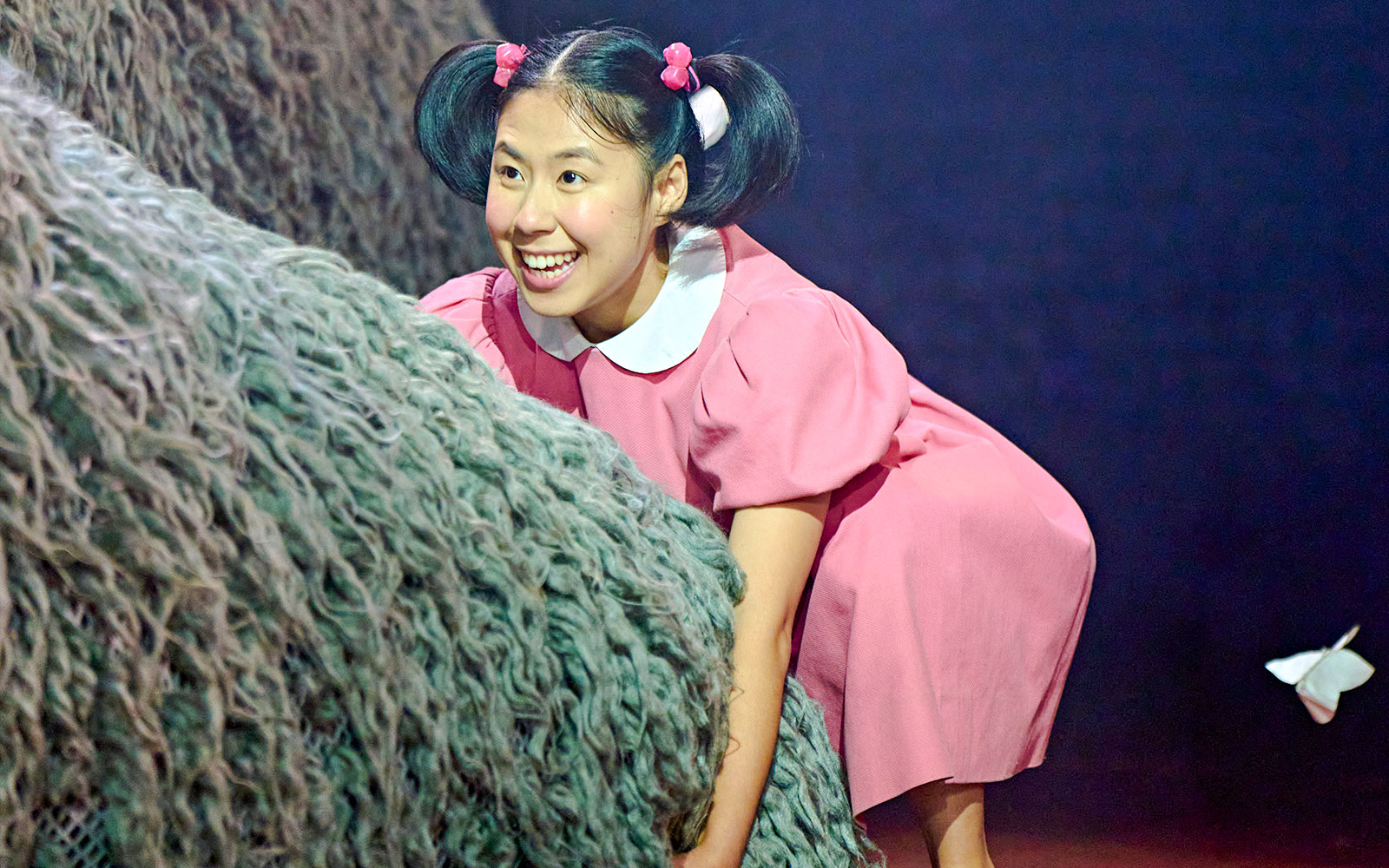 Child actor in pink dress during My Neighbour Totoro stage performance, West End.