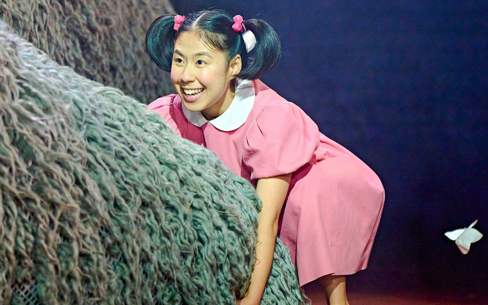 Child actor in pink dress during My Neighbour Totoro stage performance, West End.
