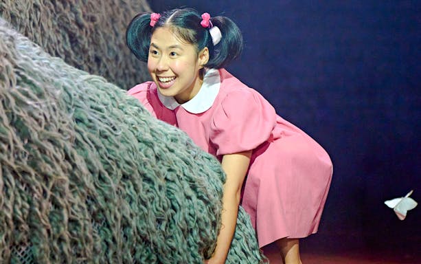 Child actor in pink dress during My Neighbour Totoro stage performance, West End.