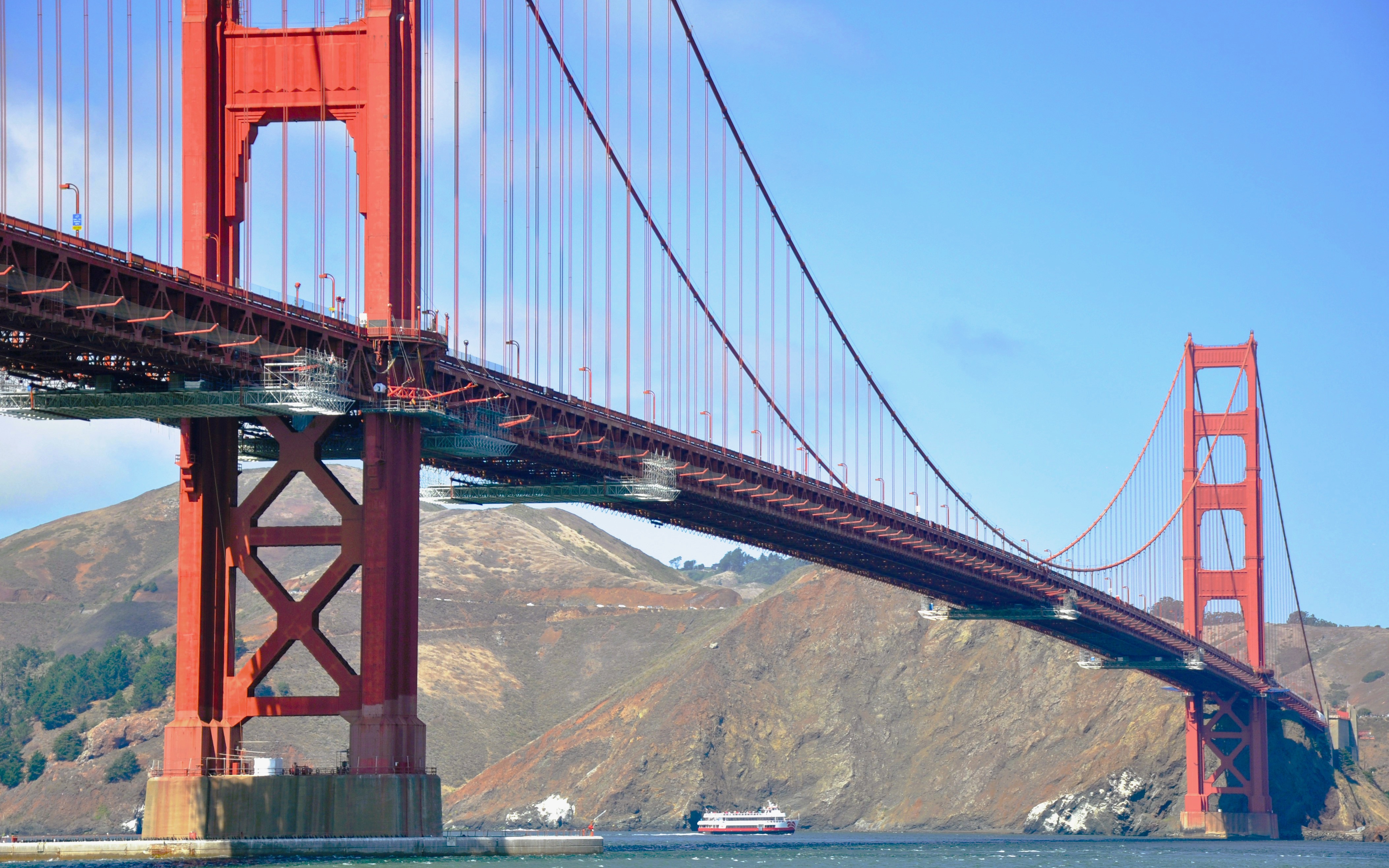 Golden Gate Bridge with cruise ship passing underneath in San Francisco Bay.