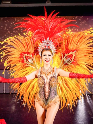 Phuket Simon Cabaret performers in vibrant costumes on stage.