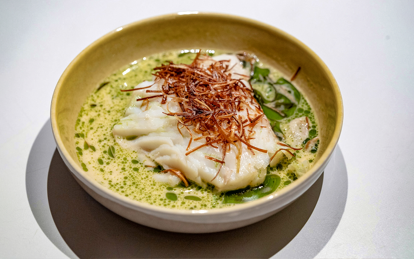 White fish dish with herbs served on Oslo dinner cruise.