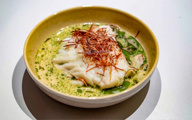 White fish dish with herbs served on Oslo dinner cruise.