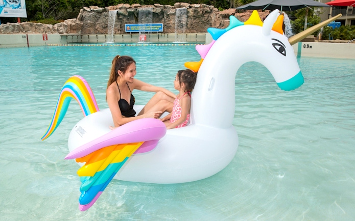 Children on unicorn float at Singapore Wild Wild Wet water park.
