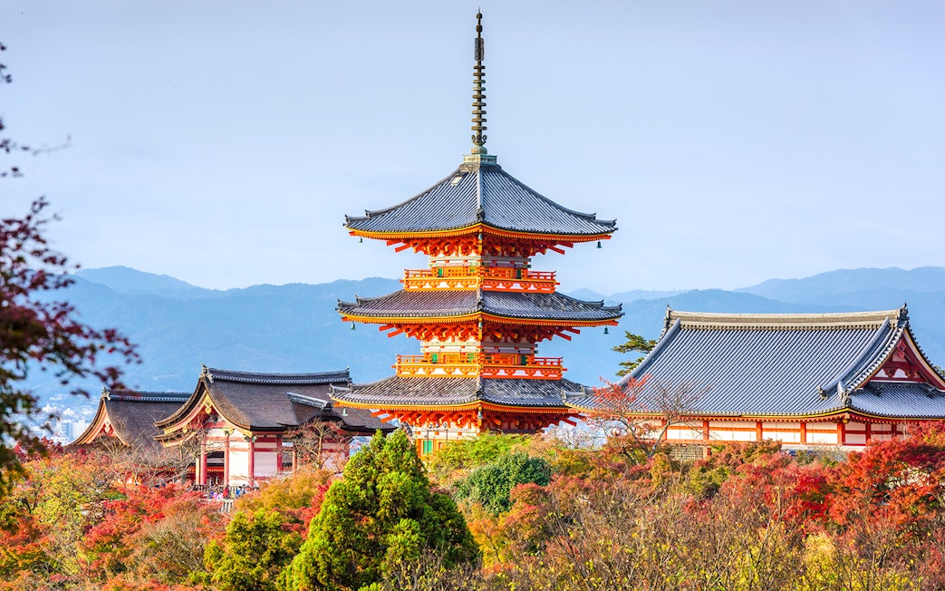 Kiyomizudera Temple pagoda surrounded by autumn foliage in Kyoto, Japan.