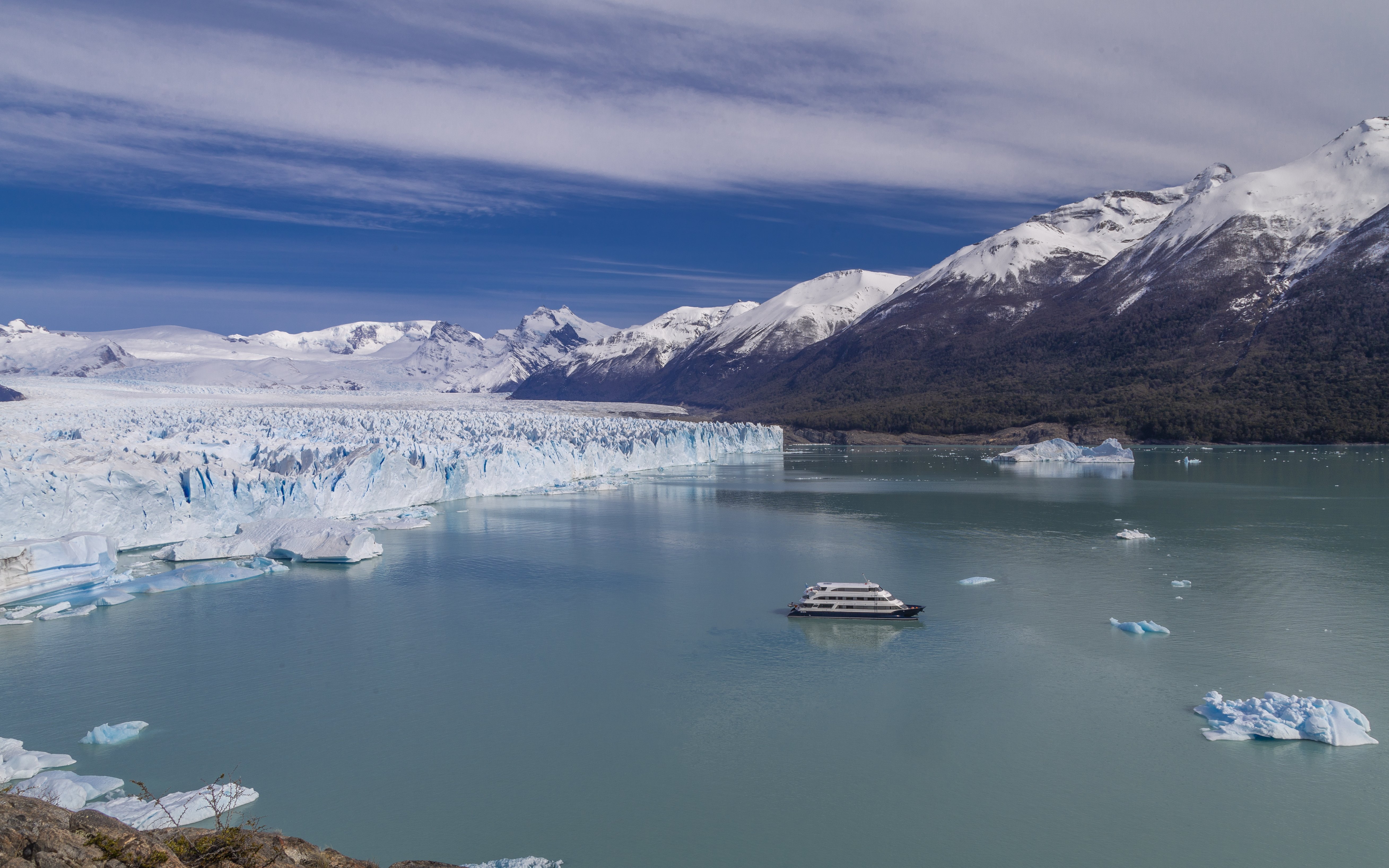 Tourists on boat viewing glaciers during Spirit of the Glaciers tour in Argentina.