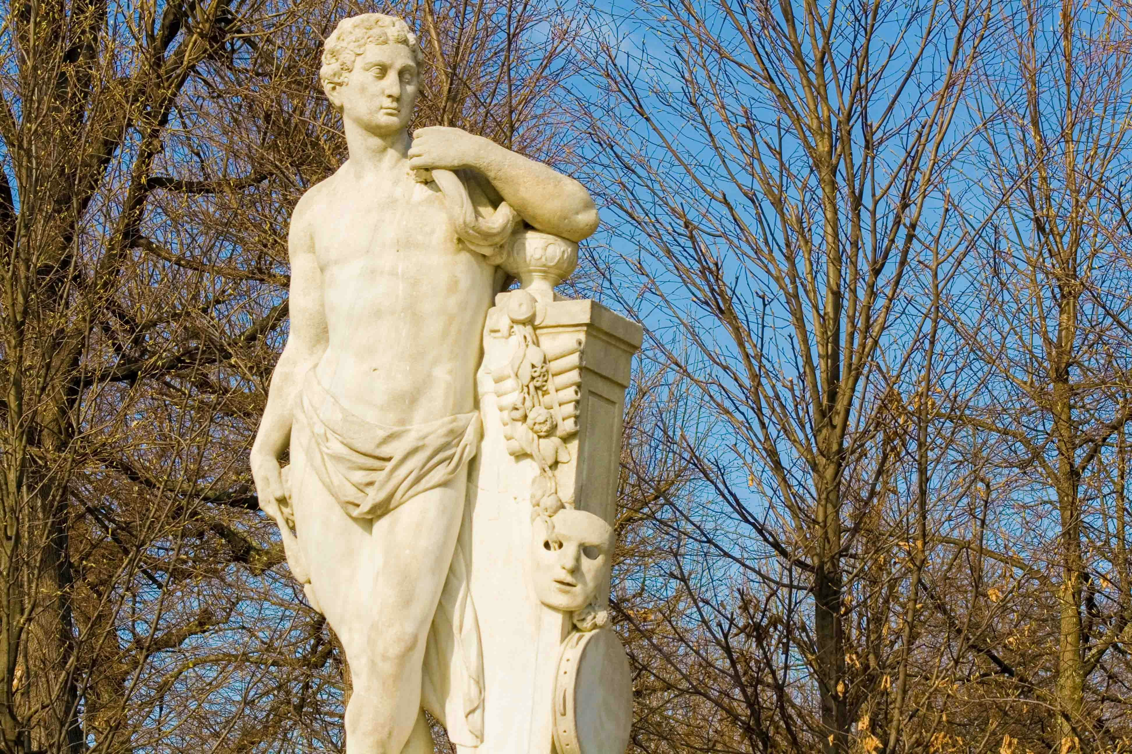 Statue of a classical figure at Schönbrunn Palace, Vienna, with bare trees in the background.