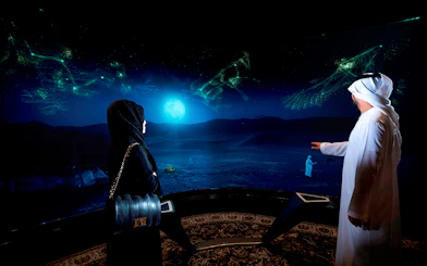 Visitors viewing digital desert landscape at Burj Khalifa At The Top SKY experience.