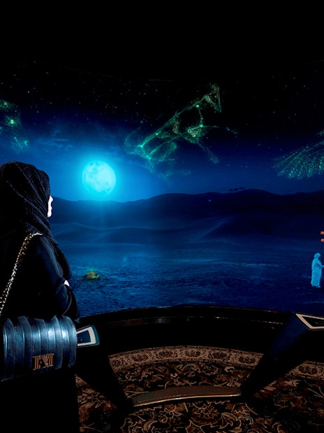 Visitors viewing digital desert landscape at Burj Khalifa At The Top SKY experience.