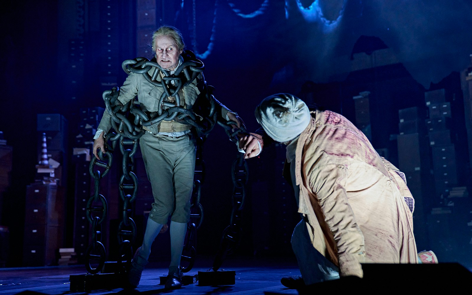 Actor in chains on stage during "A Christmas Carol - A Ghost Story" performance.