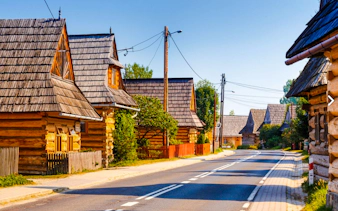 Traditional wooden houses along a road in Zakopane, Poland, seen on a private day trip from Krakow.