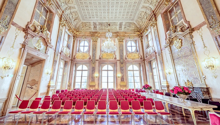 Empty red seats in ornate hall at Mirabell Palace, Salzburg.