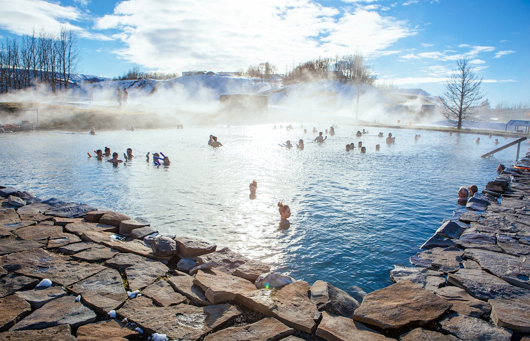 Geothermal pool with steam rising at Secret Lagoon in winter, Iceland.