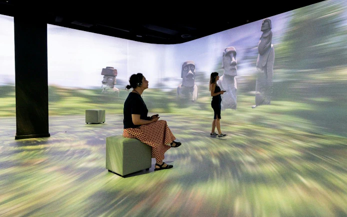 Visitors exploring immersive Easter Island exhibit at Immerse LDN: Timewalk Exhibition.