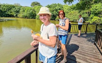 Visitors enjoying a riverside view at Bang Krachao, Bangkok.