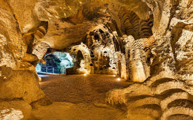 Hercules Cave interior with illuminated rock formations in Tangier, Morocco.