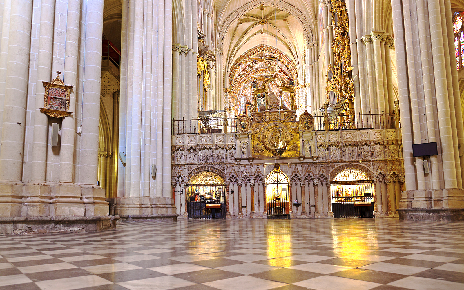Toledo Cathedral's Mozarabic Rite Chapel interior with ornate arches and religious artwork.