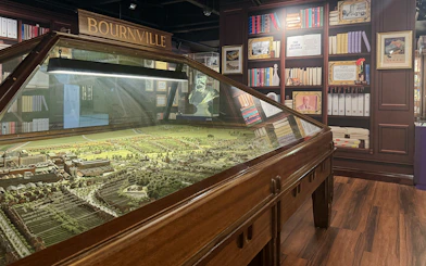 Model of Bourneville village at Cadbury World exhibit, showcasing historical layout and architecture.