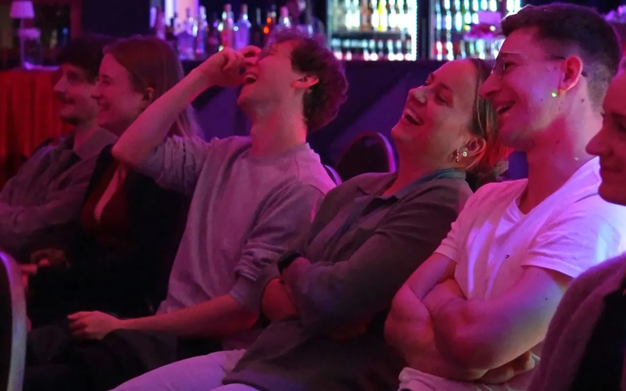 Audience laughing at Hamburg St. Pauli stand-up comedy show.