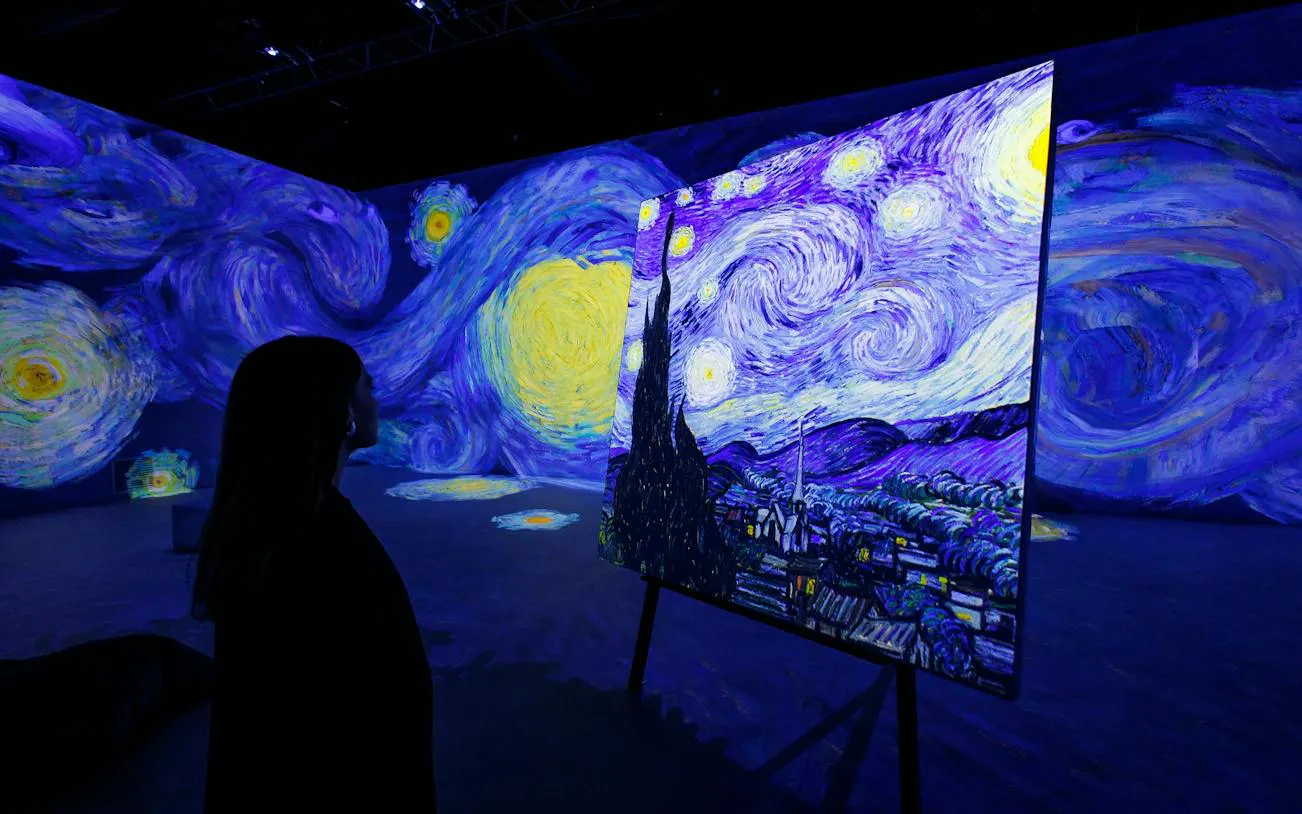 Visitor viewing Van Gogh's Starry Night at immersive exhibit in Zurich.