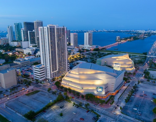 Aerial view of the Adrienne Arsht Center in Miami with surrounding cityscape and bay.