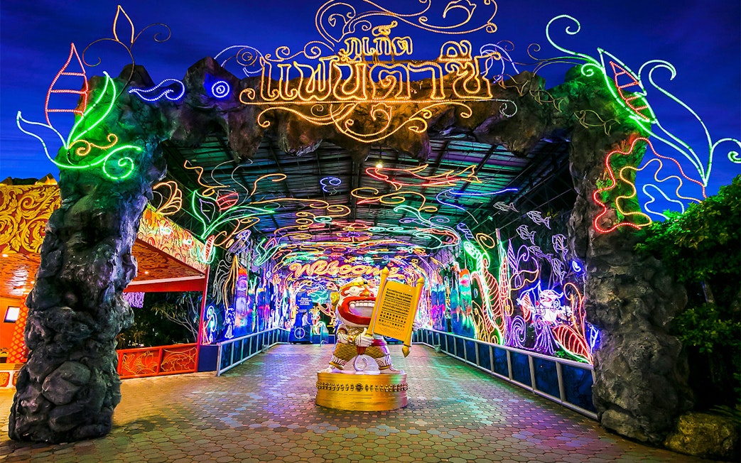 Phuket Fantasea entrance with vibrant neon lights and decorative archway.