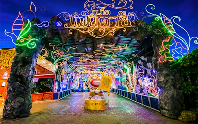 Phuket Fantasea entrance with vibrant neon lights and decorative archway.