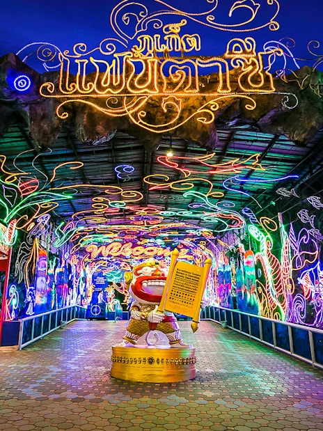 Phuket Fantasea entrance with vibrant neon lights and decorative archway.