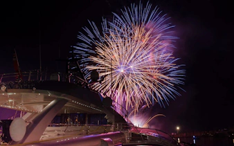 Fireworks display over a yacht during Waikiki Night Fireworks Sail.
