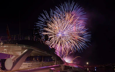 Fireworks display over a yacht during Waikiki Night Fireworks Sail.