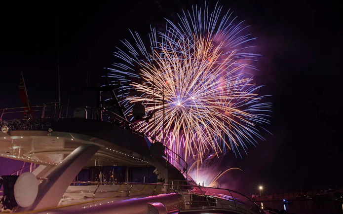 Fireworks display over a yacht during Waikiki Night Fireworks Sail.