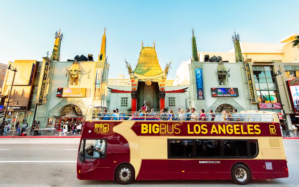 Tourists on Los Angeles Hop-On Hop-Off bus in front of TCL Chinese Theatre.