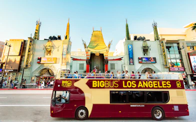 Tourists on Los Angeles Hop-On Hop-Off bus in front of TCL Chinese Theatre.