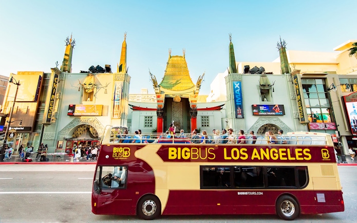 Tourists on Los Angeles Hop-On Hop-Off bus in front of TCL Chinese Theatre.