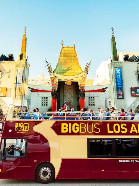 Tourists on Los Angeles Hop-On Hop-Off bus in front of TCL Chinese Theatre.