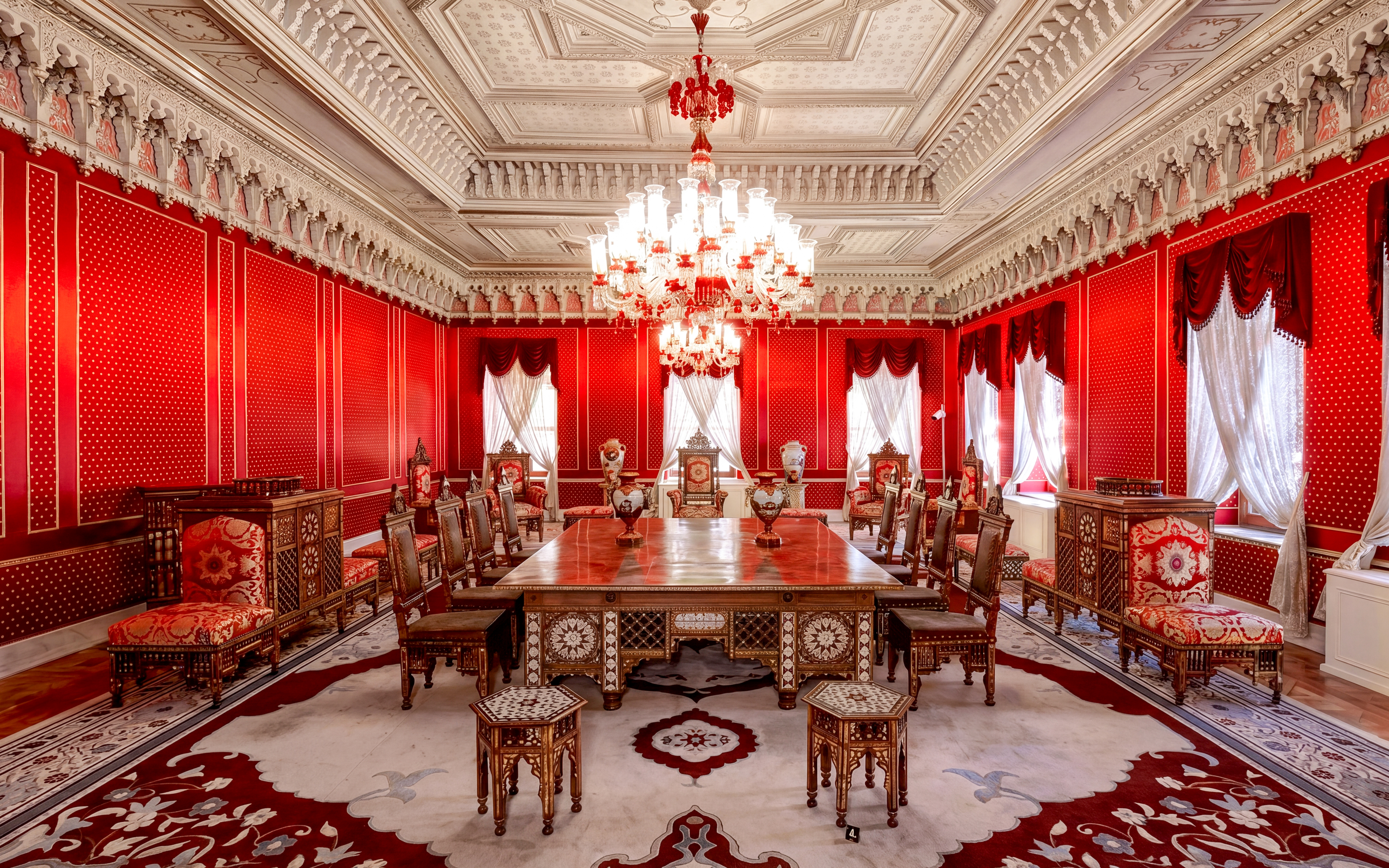 Yildiz Palace interior with ornate red decor and chandelier, Istanbul.