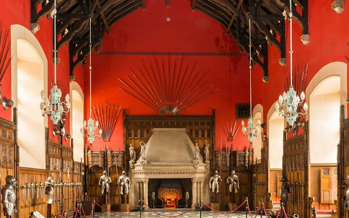Great Hall interior with medieval armor and weapons display at Edinburgh Castle.