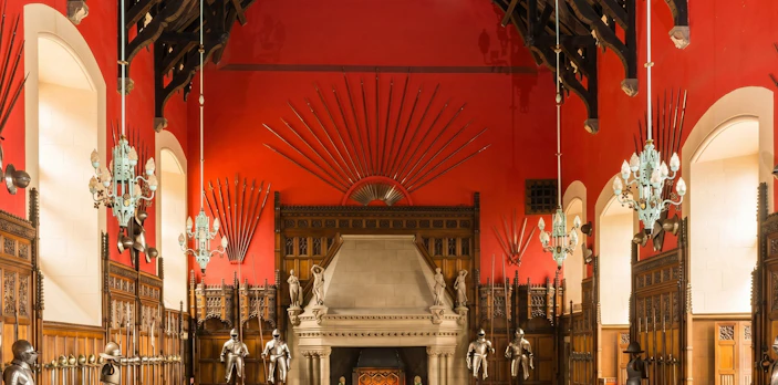 Great Hall interior with medieval armor and weapons display at Edinburgh Castle.