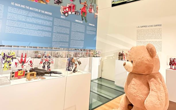 Toy exhibits at MINT Museum of Toys, featuring Transformers and a large teddy bear.