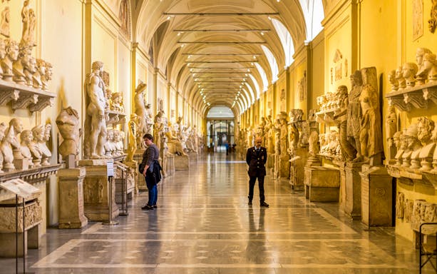 Vatican Museums gallery with classical sculptures, Rome.