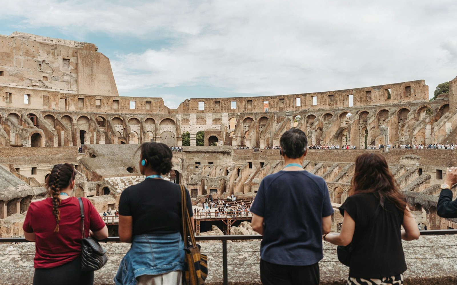 Visitors exploring the interior of the Colosseum on a private guided tour in Rome.