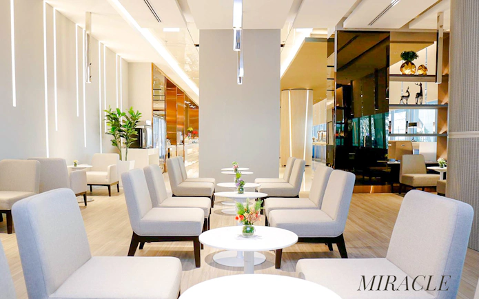Miracle Lounge seating area at Bangkok airport, Thailand with modern decor and tables.