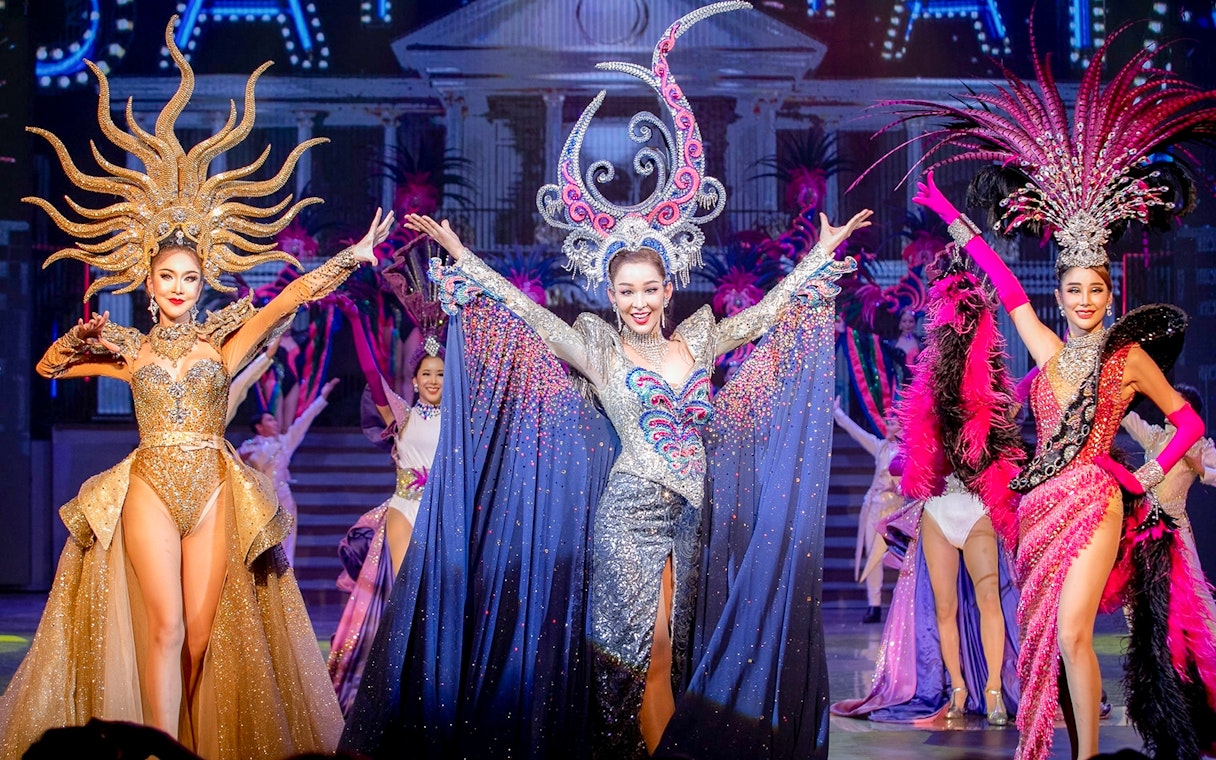 Performers in elaborate costumes on stage at Tiffany's Show, Pattaya.