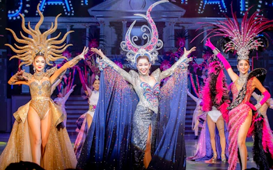 Performers in elaborate costumes on stage at Tiffany's Show, Pattaya.