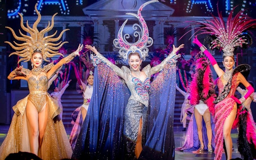 Performers in elaborate costumes on stage at Tiffany's Show, Pattaya.
