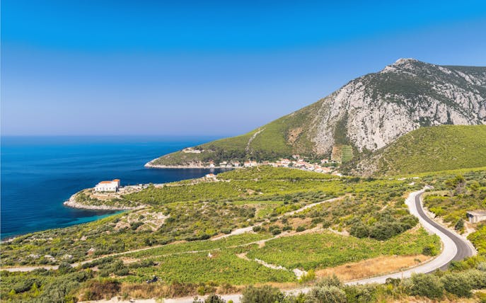 Sea coast view of Peljesac Peninsula, Croatia, with a winding road and coastal village.