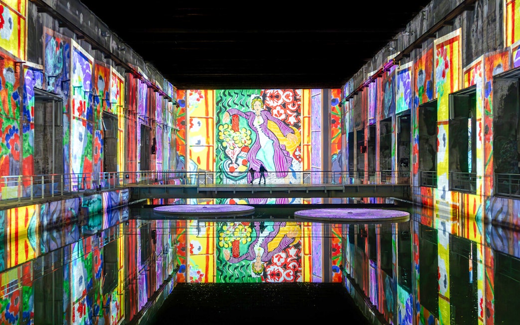 Matisse artwork projected on walls at Bassins des Lumières exhibition.