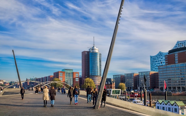 People walking near Elbphilharmonie in Hamburg on a guided tour.