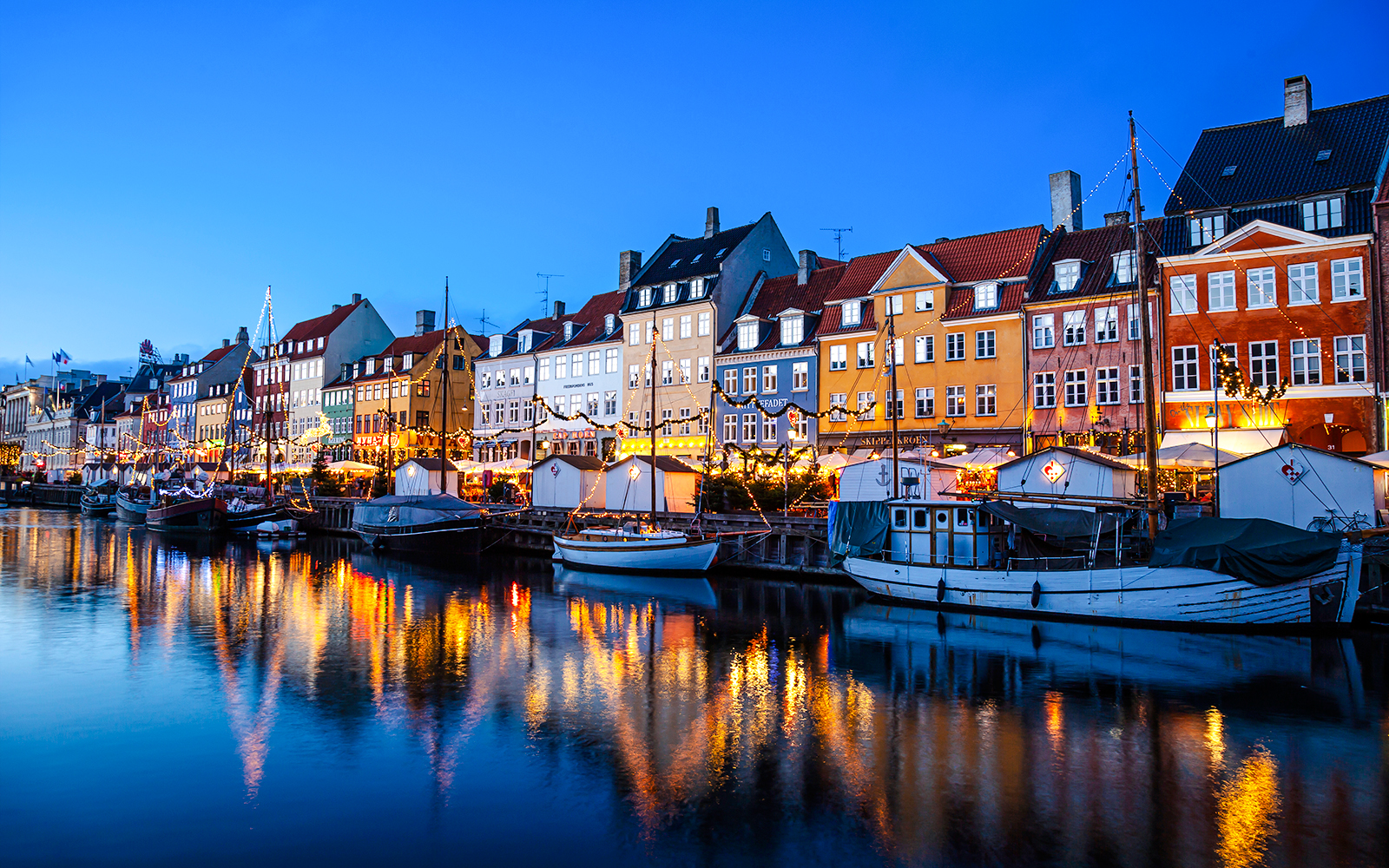 Nyhavn Canal at sunset with Christmas lights, Copenhagen, Denmark.