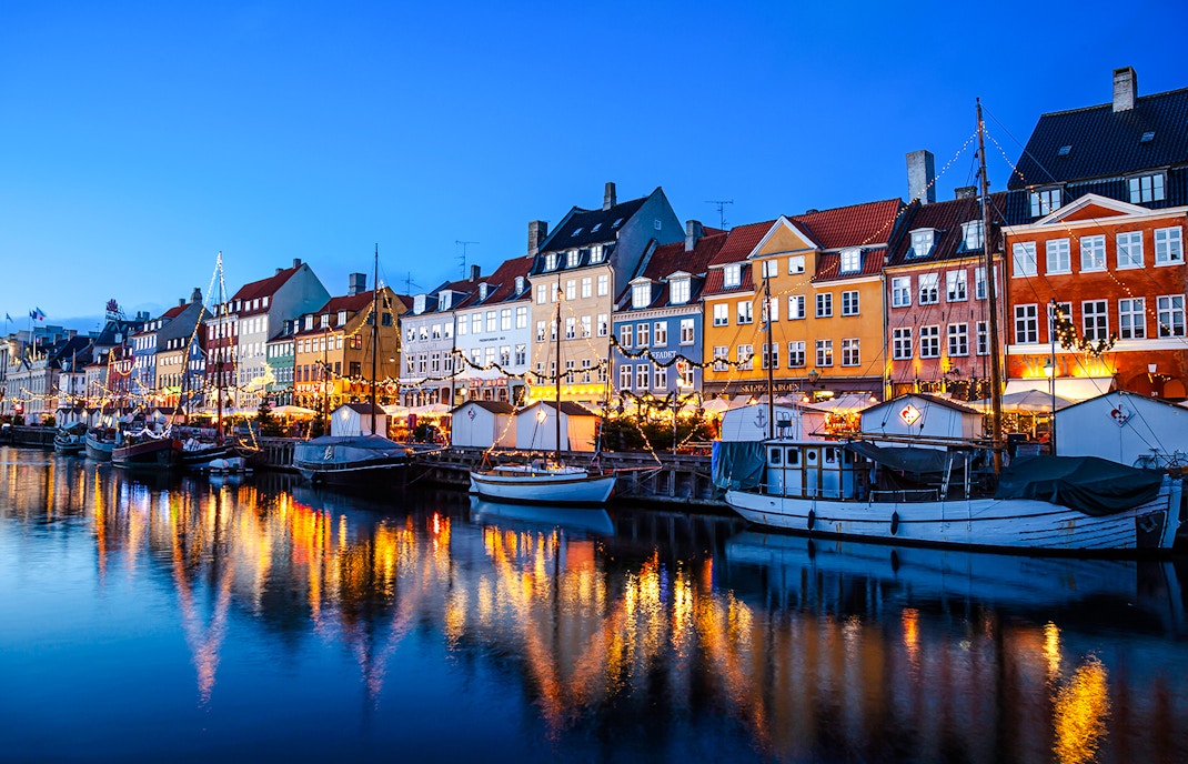 Nyhavn Canal at sunset with Christmas lights, Copenhagen, Denmark.